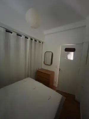 a bedroom with a bed and a mirror and a door at Appart Centre ville à 2 min à pied de la mer in Nice