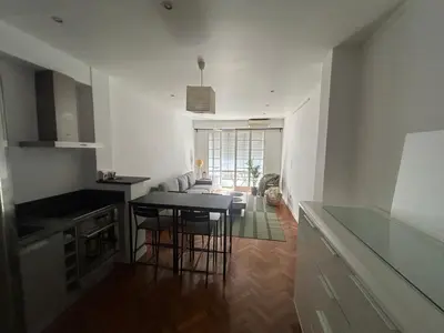 a kitchen with a table and chairs in a room at Appart Centre ville à 2 min à pied de la mer in Nice