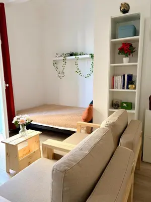 a living room with a couch and a bed at Studio avec balcon - Centre-ville & plage à 2 min in Nice
