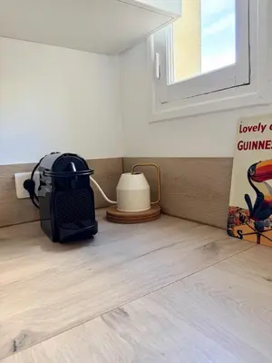 a toaster sitting on the floor next to a window at Studio avec balcon - Centre-ville & plage à 2 min in Nice