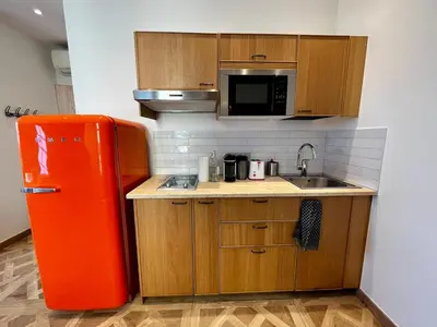 a kitchen with an orange refrigerator and a sink at Oiseau du paradis studio central pour 4 personnes in Cagnes-sur-Mer