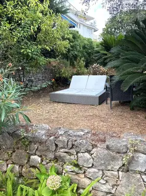 a bed sitting on the ground in a garden at NiceVueEnsoleille in Nice