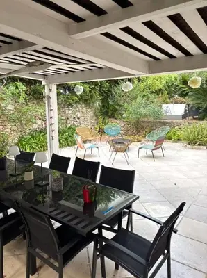 a table and chairs sitting on a patio at NiceVueEnsoleille in Nice
