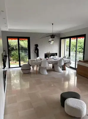 a large living room with a table and chairs at NiceVueEnsoleille in Nice