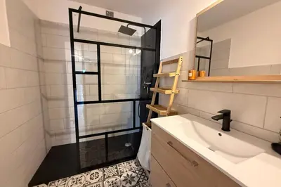 a bathroom with a shower with a glass door at Modern apartment with terrace - ideal location in Cagnes-sur-Mer
