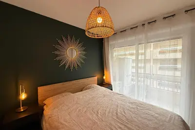 a kitchen with white cabinets and a refrigerator at Modern apartment with terrace - ideal location in Cagnes-sur-Mer