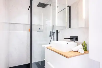 a white bathroom with a sink and a shower at Super flat in Carré d'Or - 1 minute from the sea in Nice