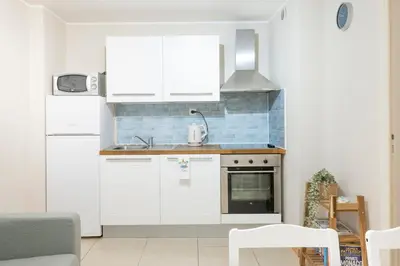 a kitchen with white cabinets and a stove top oven at 2 bedroom apartment in the center of Nice old town in Nice