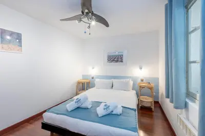 a bedroom with a bed with two pillows on it at 2 bedroom apartment in the center of Nice old town in Nice