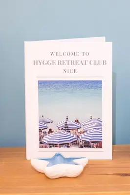 a picture of a beach with blue and white striped umbrellas at 2 bedroom apartment in the center of Nice old town in Nice