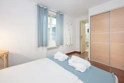 a bedroom with a bed with white pillows on it at 2 bedroom apartment in the center of Nice old town in Nice