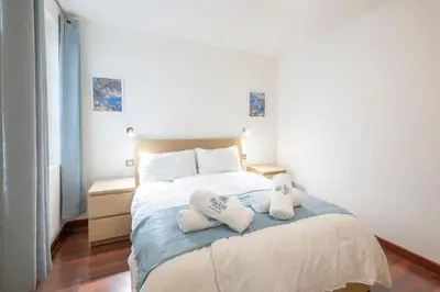 a bedroom with a bed with two pillows on it at 2 bedroom apartment in the center of Nice old town in Nice