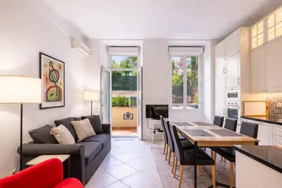 a living room with a couch and a table at The Apartment with the Garden Studio in Nice