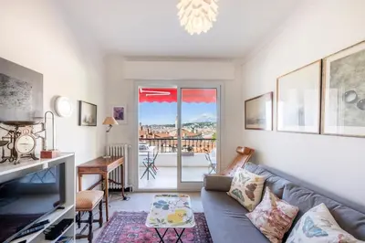 a living room with a couch and a table at Azur Balcony Apartment Classic Charm with View in Nice