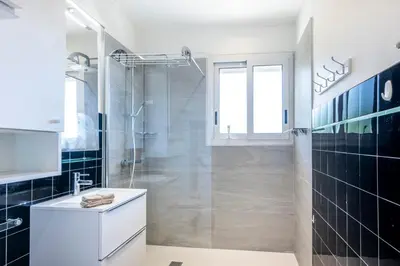 a bathroom with a glass shower and a sink at Azur Balcony Apartment Classic Charm with View in Nice