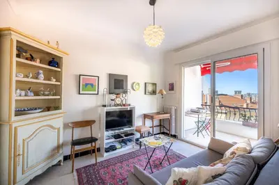 a living room with a couch and a table at Azur Balcony Apartment Classic Charm with View in Nice