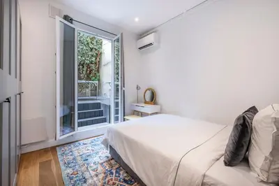 a bedroom with a bed and a large window at Chic 3BR Oasis Near the Sea AC 2 Terraces in Nice