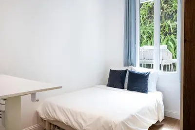 a white bedroom with a bed and a window at Chic 3BR Oasis Near the Sea AC 2 Terraces in Nice