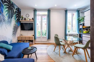 a living room with a blue couch and a table at Chic 3BR Oasis Near the Sea AC 2 Terraces in Nice