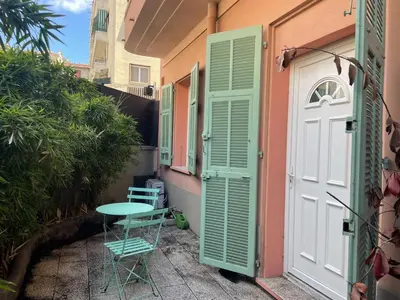 a small patio with a table and chairs next to a door at Beautiful studio with terrace - Nice Liberation in Nice
