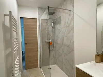 a shower with a glass door in a bathroom at Beautiful studio with terrace - Nice Liberation in Nice