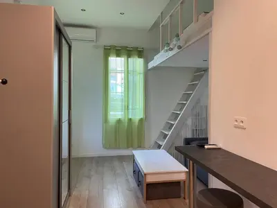 a room with a staircase and a green curtain at Beautiful studio with terrace - Nice Liberation in Nice