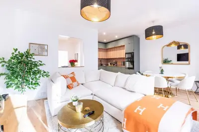 a living room with a white couch and a table at Appartement Assalit Two bedrooms in Nice in Nice