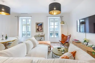 a living room with white furniture and windows at Appartement Assalit Two bedrooms in Nice in Nice
