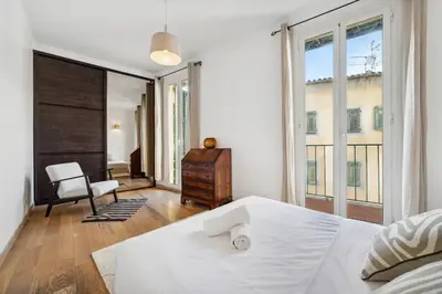 a bedroom with a white bed and a desk and windows at L'Essentiel Confort - Solaire, Plage, Vieux Nice - by Studio Y in Nice