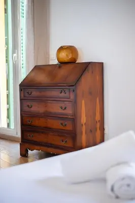 a wooden dresser with a bowl on top of it at L'Essentiel Confort - Solaire, Plage, Vieux Nice - by Studio Y in Nice