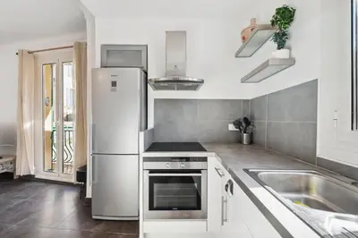 a kitchen with a refrigerator and a sink at L'Essentiel Confort - Solaire, Plage, Vieux Nice - by Studio Y in Nice