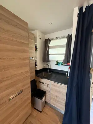 a small kitchen with a sink and a window at Air-conditioned studio comfort & cozy in Saint-Laurent-du-Var