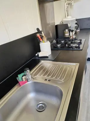 a kitchen counter with a sink in a kitchen at très grande chambre climatisée plein centre Nice avec balcon in Nice