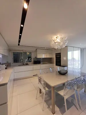 a kitchen with a dining table and chairs at Penthouse - Vue mer panoramique - SPA privé - Piscine commune in Saint-Laurent-du-Var