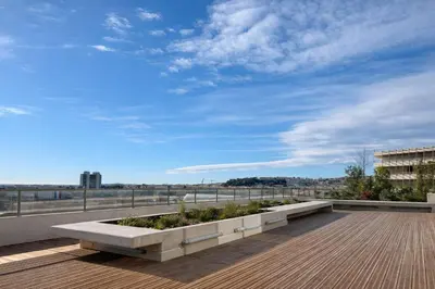 a balcony with a bench on top of a building at Luxury apartment with balcony & rooftop in Nice