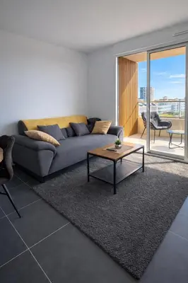 a living room with a couch and a coffee table at Luxury apartment with balcony & rooftop in Nice