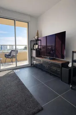 a living room with a large flat screen tv at Luxury apartment with balcony & rooftop in Nice