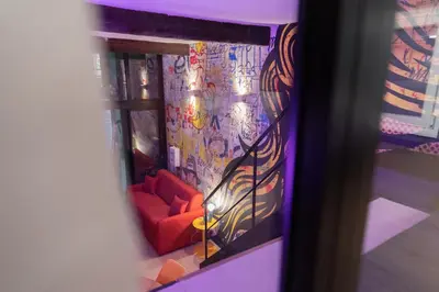 a room with a couch and a wall with graffiti at Loft de 6 couchages, bord de mer à Nice in Nice