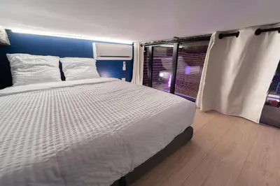 a bedroom with a large bed and a window at Loft de 6 couchages, bord de mer à Nice in Nice
