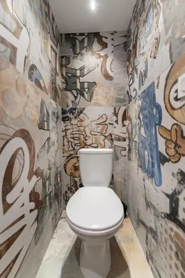 a bathroom with a toilet with graffiti on the walls at Loft de 6 couchages, bord de mer à Nice in Nice