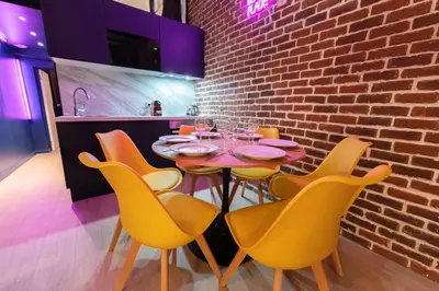 a dining room with a table and yellow chairs at Loft de 6 couchages, bord de mer à Nice in Nice