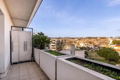 a balcony with a view of a city at 2BR Sea View Apartment with Pool & AC in Cagnes-sur-Mer