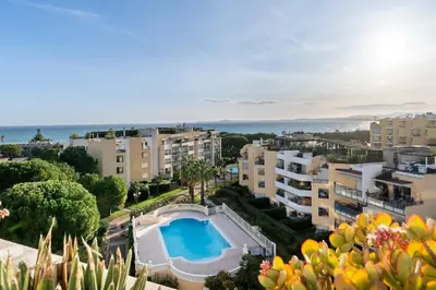 an apartment with a swimming pool and some buildings at 2BR Sea View Apartment with Pool & AC in Cagnes-sur-Mer