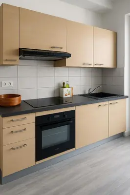 a kitchen with wooden cabinets and a black oven at Large 1 bedroom apartment, balcony, very central Nice in Nice