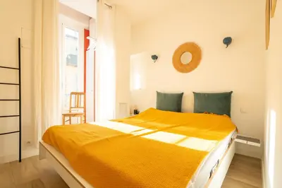 a bedroom with a bed with a pillow and a window at A l'Élegance in Nice