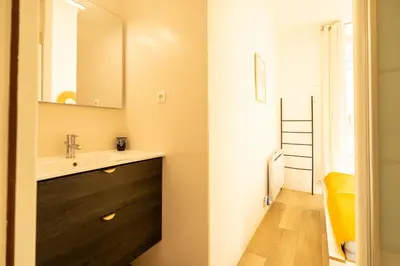 a kitchen with white cabinets and a washing machine at A l'Élegance in Nice