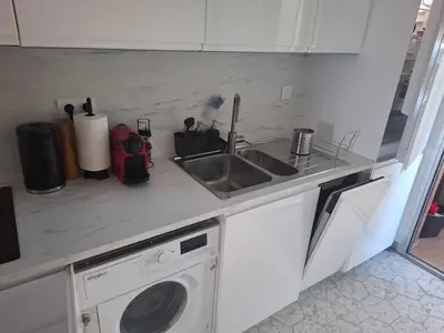 a kitchen counter with a sink and a washing machine at Heaven Nice in Nice