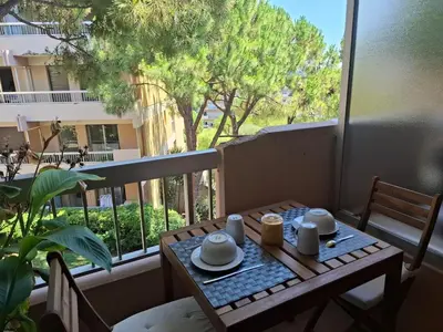 a table and chairs on a balcony with a view of a building at Heaven Nice in Nice