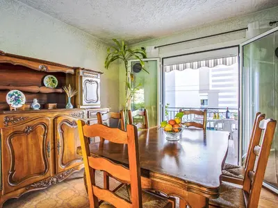 a dining room with a wooden table and chairs at Holiday Home Maison Valensole by Interhome in Cagnes-sur-Mer