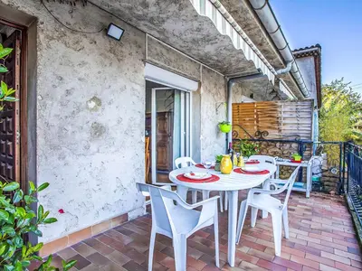a white table and chairs on a patio at Holiday Home Maison Valensole by Interhome in Cagnes-sur-Mer